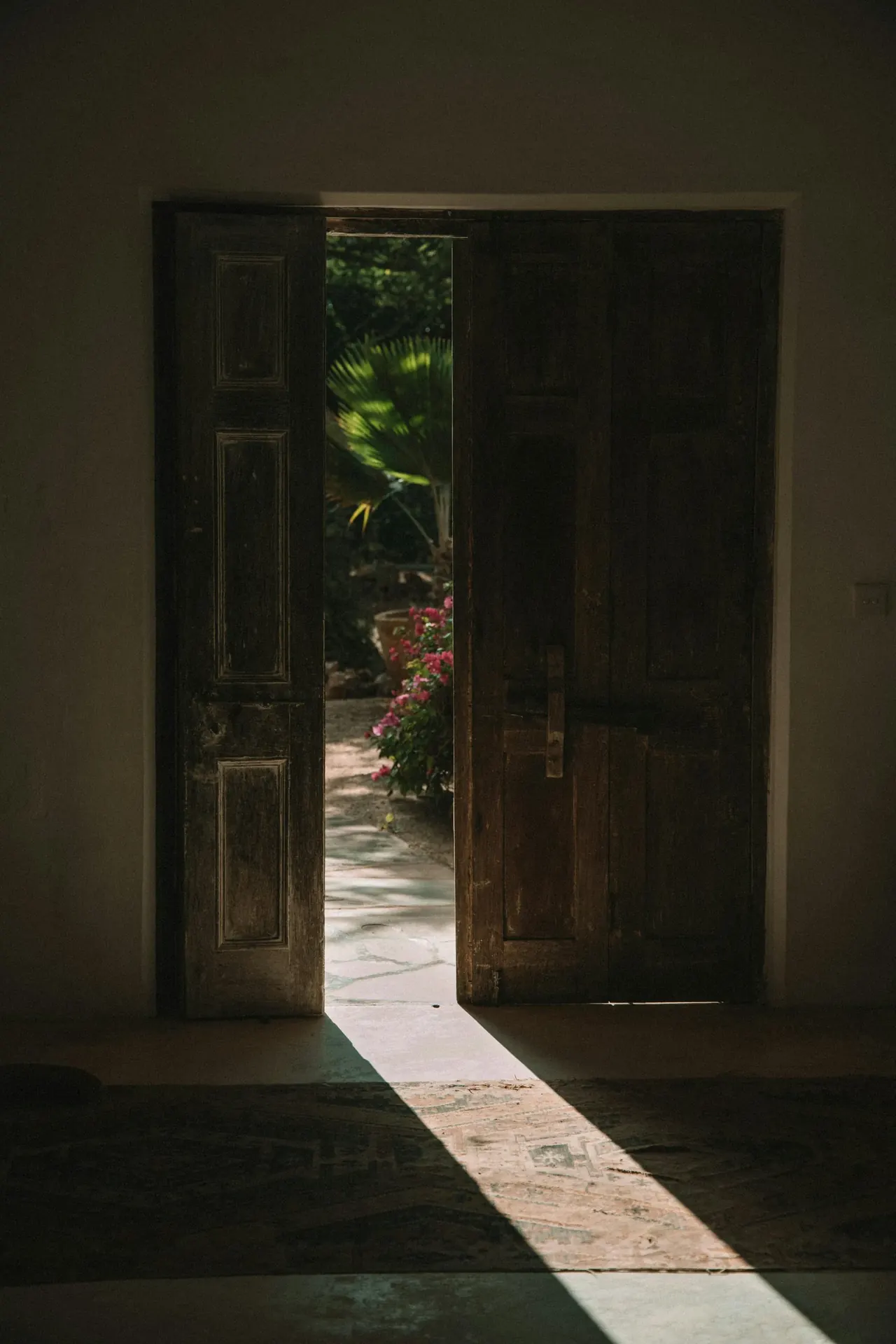Sunlit doorway opening into AKARA clinic